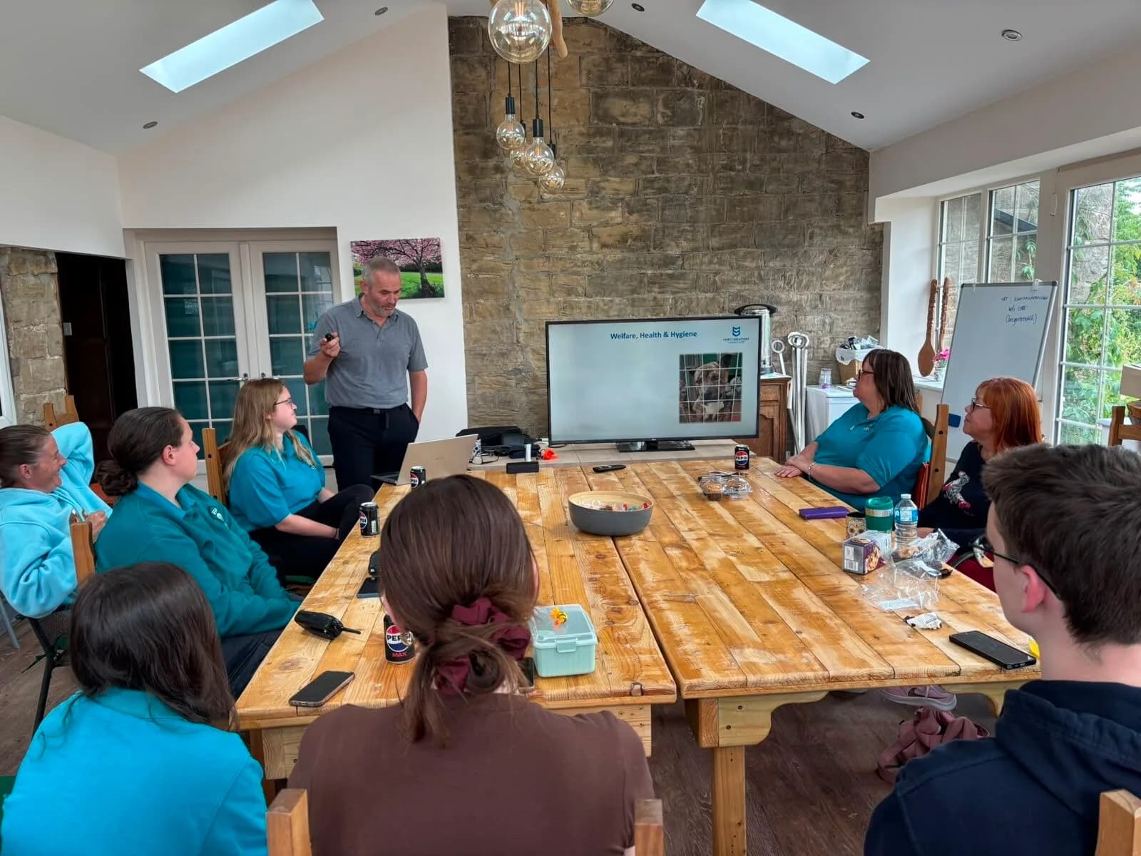 An associate trainer delivering Dangerous Dogs Awareness training to a seated group of staff